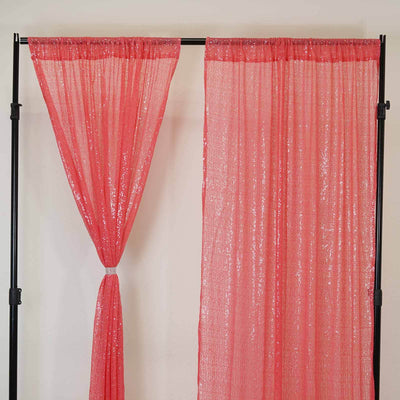Pink sequin curtain panels hanging on a black frame.
