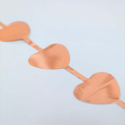 Copper heart garland on a plain background