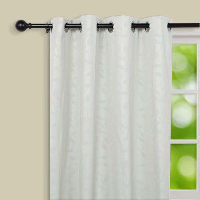Sheer white curtain panel with leaf pattern, hung on a black curtain rod.