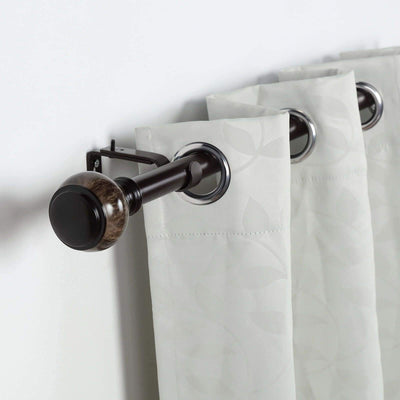 Curtain rod with decorative finial and sheer curtains