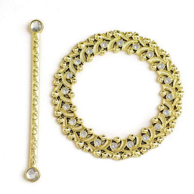 Gold decorative jewelry set with intricate design and sparkling stones