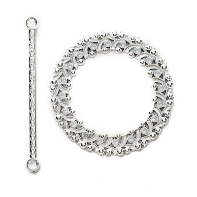 Silver decorative jewelry set with intricate floral designs.