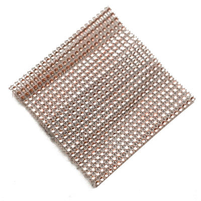 Rose gold mesh fabric swatch on a white background.