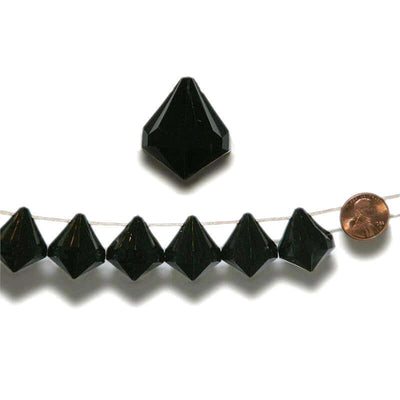 Black crystal pyramid beads on string with a penny for scale