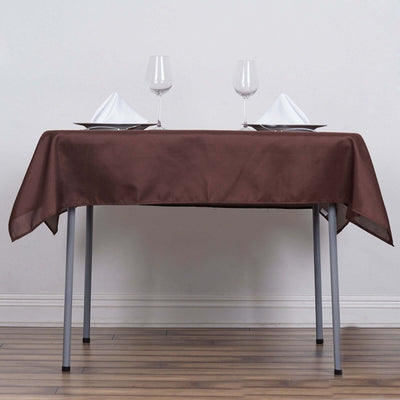Brown tablecloth elegantly draped over a table set with glasses and napkins.