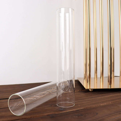 Clear glass vase on a wooden surface, partially tipped over.