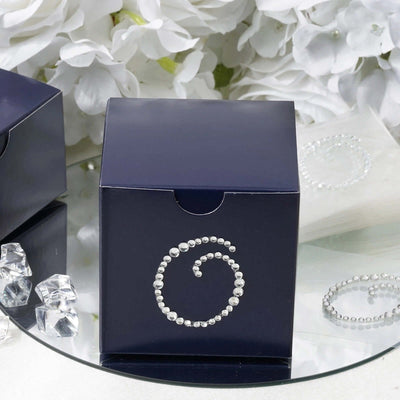 Navy gift box with a decorative swirl design and rhinestones