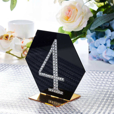 Black acrylic table number 4 with rhinestones, elegant event decor.