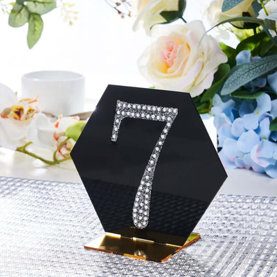 Hexagon table number 7 with rhinestones on a gold base, elegant event decor.