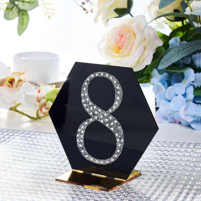Black hexagon table number 8 with rhinestones and gold base, elegantly displayed.