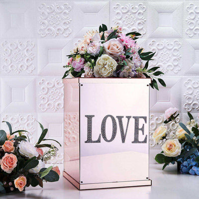 Mirrored flower box with "LOVE" design, adorned with pink and white flowers.