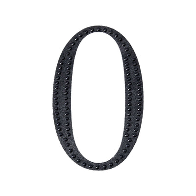 Black decorative number zero with studded details on a plain background.