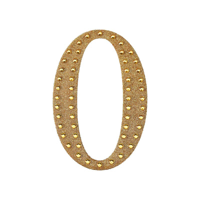 Gold glitter number zero with studded accents on a plain background.