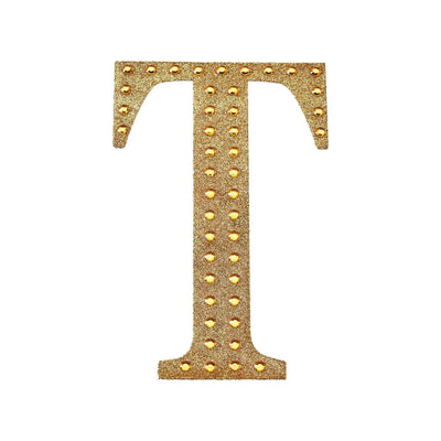 Gold studded letter "T" on a white background