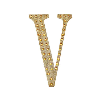 Gold glitter letter "V" adorned with rhinestones on a white background.