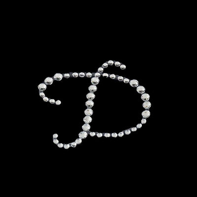 Rhinestone letter "D" design on a black background.