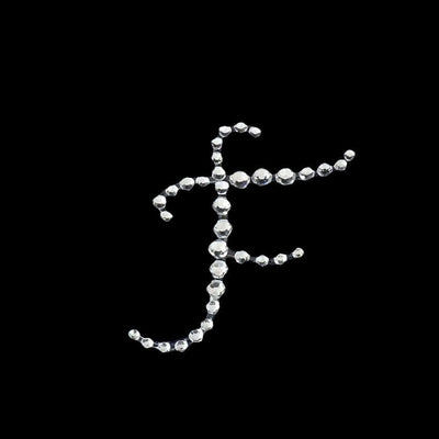 Rhinestone letter "F" design on a black background.
