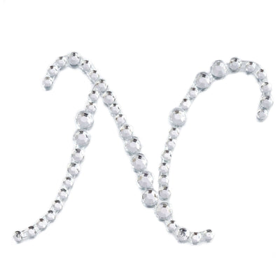 Silver rhinestone letter "N" on a white backdrop.
