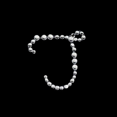 Silver rhinestone letter J on a black background.