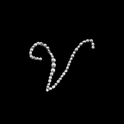 Silver rhinestone letter "V" design on a black background.