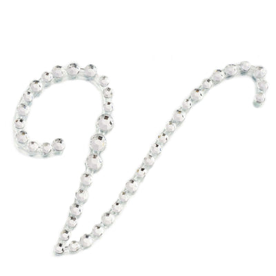 Silver beaded decorative trim in a curvy shape on a plain backdrop
