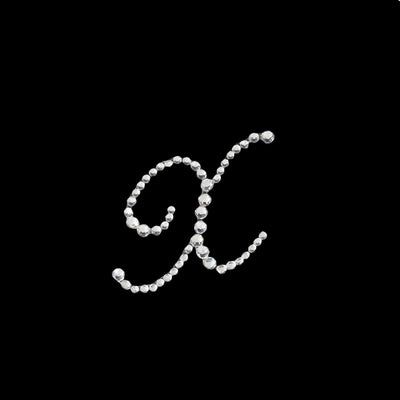 Rhinestone letter K design on a black background.