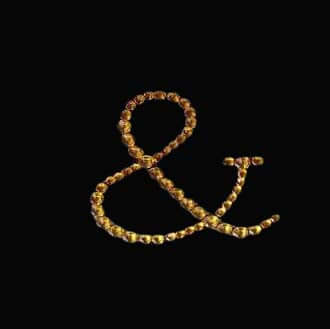 Gold decorative ampersand symbol on a black background.