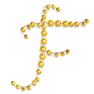 Decorative letter F made of yellow rhinestones on a white background