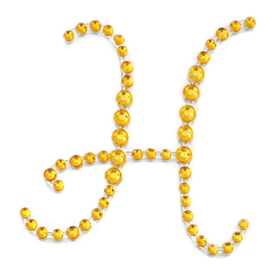 Yellow rhinestone letter "H" decoration on a white background.