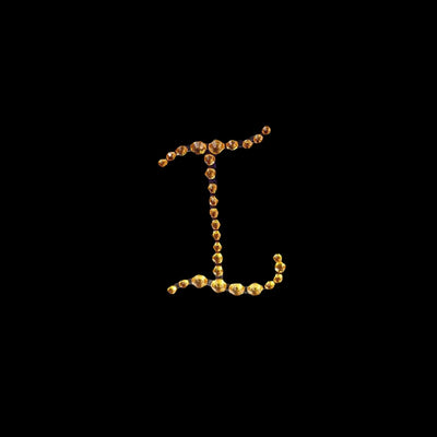 Golden letter "L" made of gemstones on a black background.