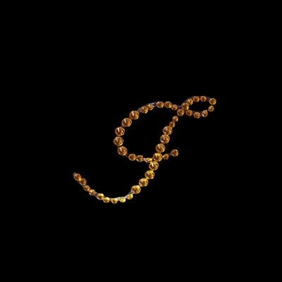 Golden bead necklace in elegant, flowing design.