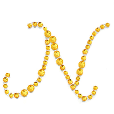 Yellow rhinestone letter "N" design on a white background