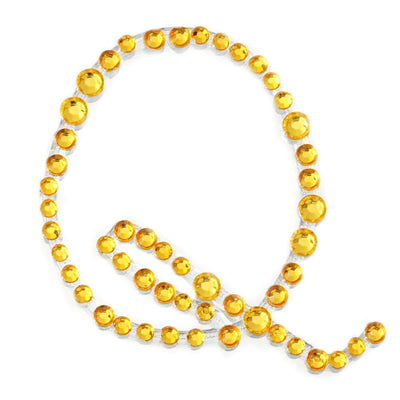 Yellow rhinestone embellishments in various sizes, arranged in a decorative line.