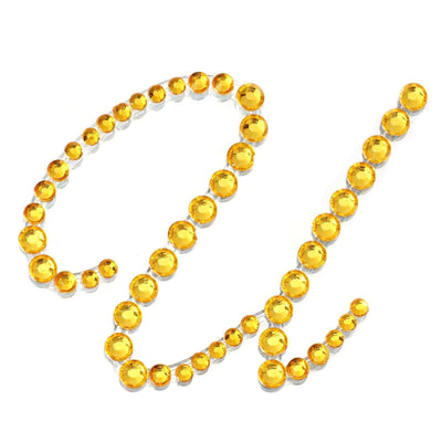 Yellow rhinestone embellishments forming the letters "G" and "L"