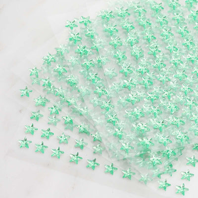 Green star-shaped embellishments on transparent sheets