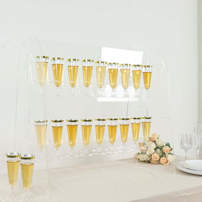 Acrylic champagne flute display with golden drinks and roses.