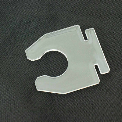 Clear plastic clip for securing items, studio shot against black background.