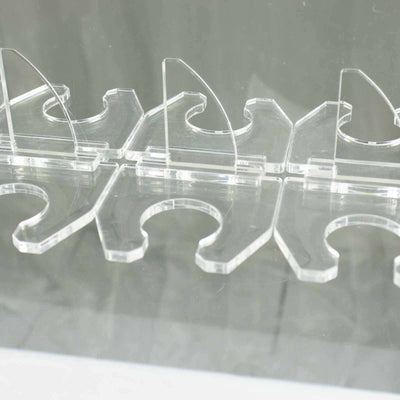 Clear acrylic display stands arranged in a row.