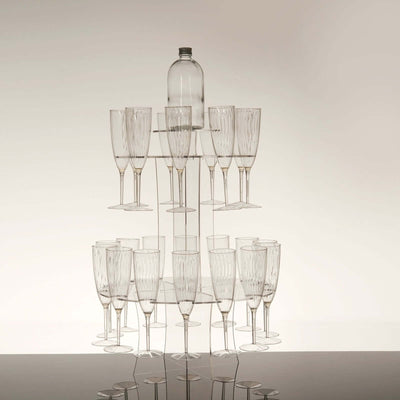 Clear glass champagne tower with a bottle on top.