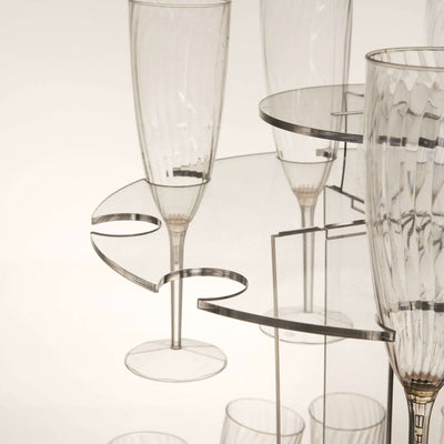 Elegant transparent champagne flutes on a modern display stand