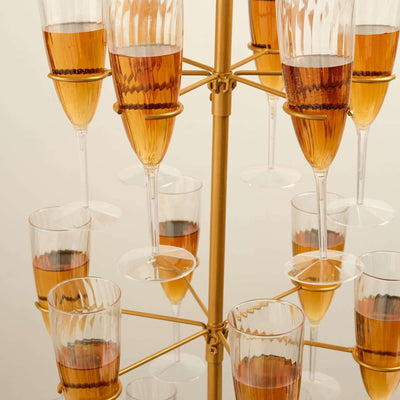 Decorative glass display with champagne flutes and amber liquid