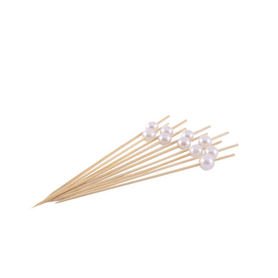 Pearl-tipped cocktail picks on a white background