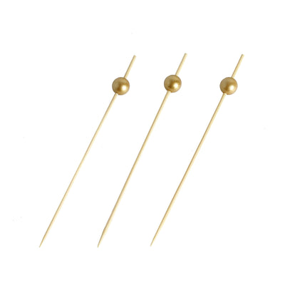 Gold cocktail picks with round tops, ideal for appetizers and garnishes.