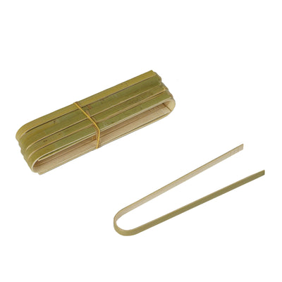 Set of bamboo skewers, bundled and loose, on a white background.