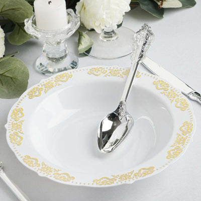 Elegant white serving bowl with gold floral trim and silver serving spoon.