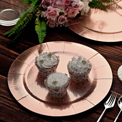 Elegant decorative cupcakes on rose gold plates with floral accents.