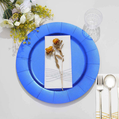 Elegant blue plate setting with dried flowers and cutlery.