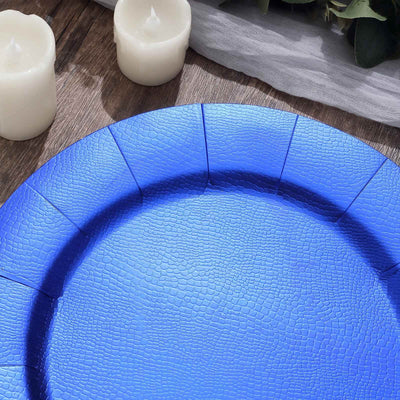 Blue textured serving plate on a wooden table with candles.