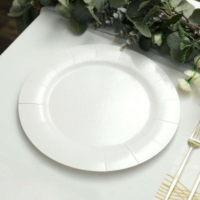White disposable plate on a table with greenery