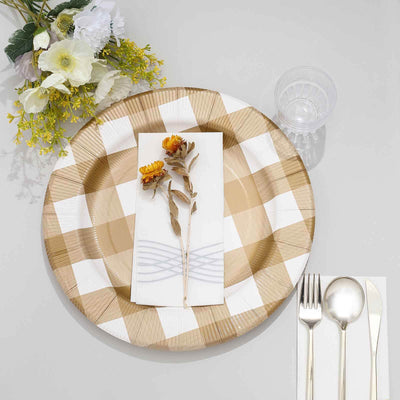 Elegant table setting with floral accent on a checkered plate.